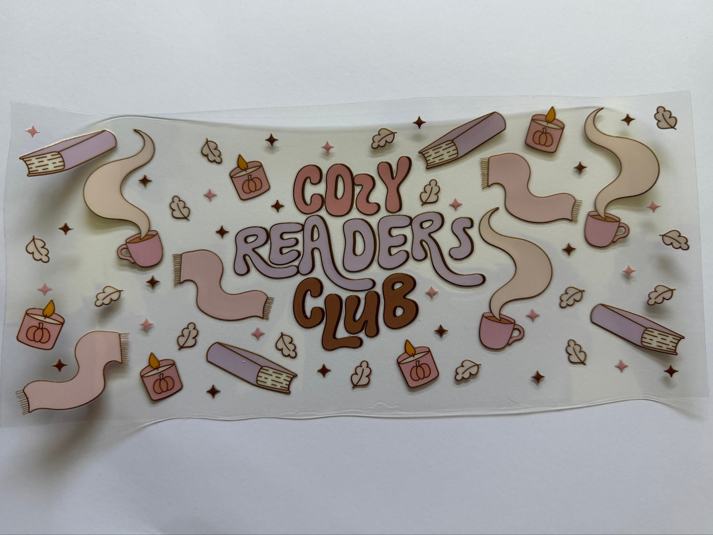 Sticker with 'Cozy Readers Club' text and reading-themed illustrations on a white background