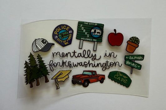Collection of colorful pins on a white background with 'Mentally in Forks Washington' text.