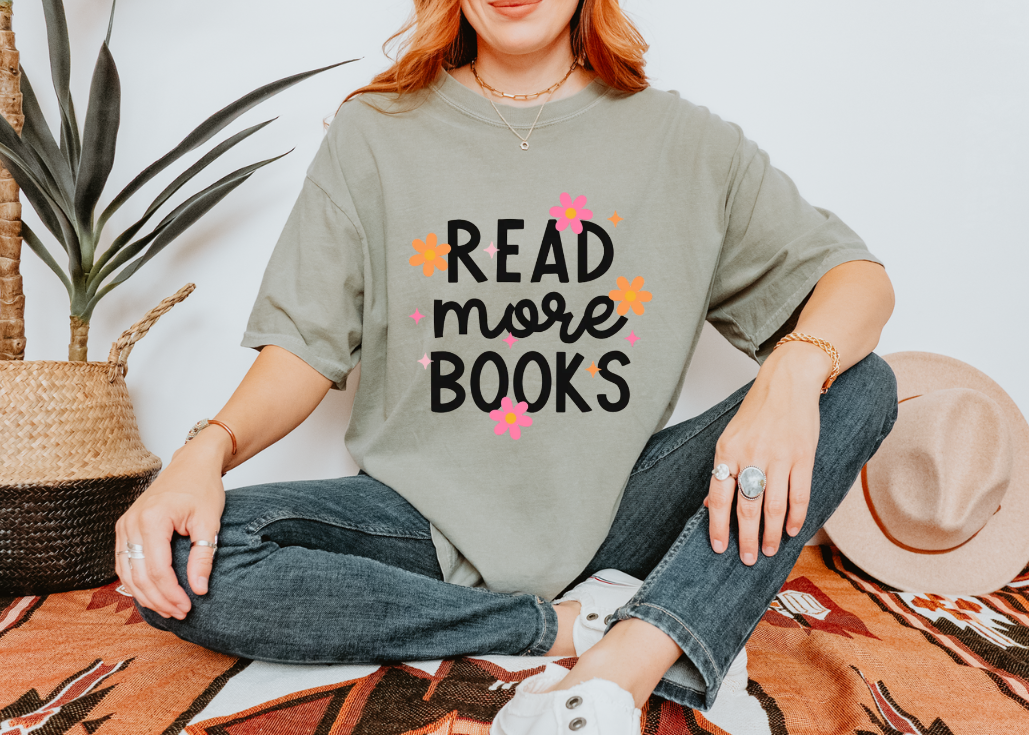 Person wearing a shirt with 'Read more books' text in a casual setting.