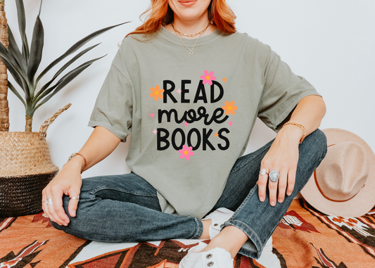 Person wearing a shirt with 'Read more books' text in a casual setting.