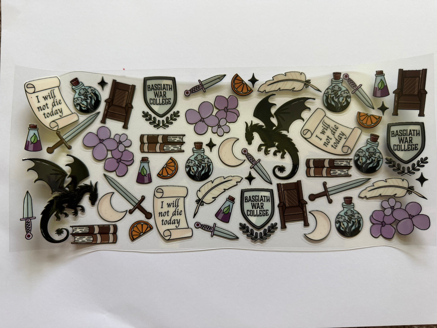 Collection of themed stickers with dragons, books, and other elements on a white background