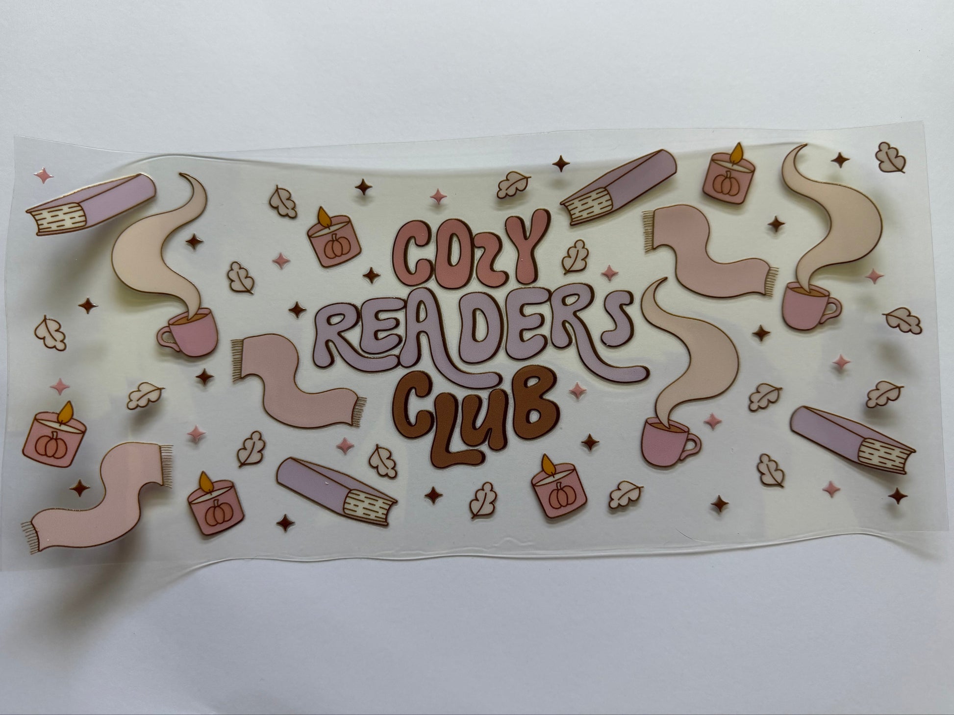 Sticker with 'Cozy Readers Club' text and reading-themed illustrations on a white background