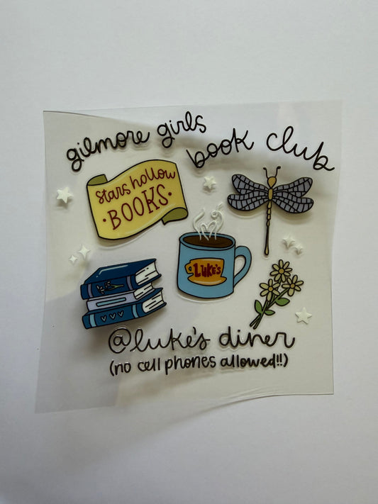 Decorative pins with book-themed designs on a white background