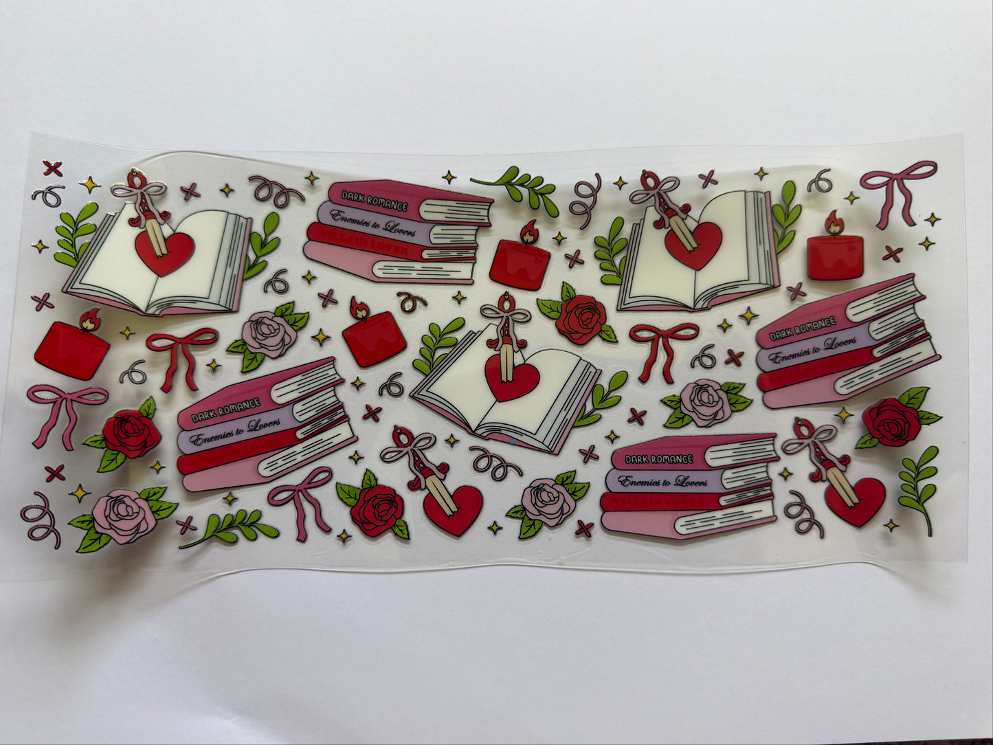 Decorative sticker sheet with books, hearts, and flowers on a white background