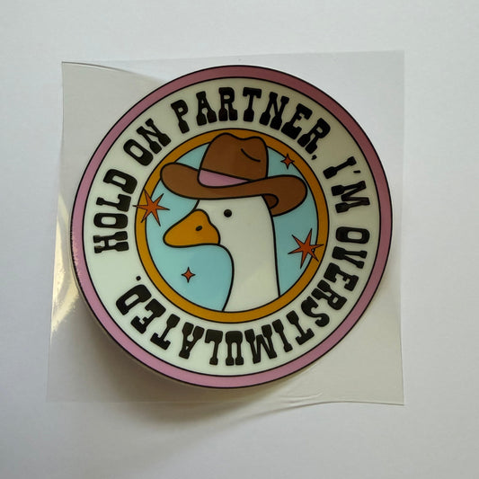 Round sticker with duck illustration and text on a white background