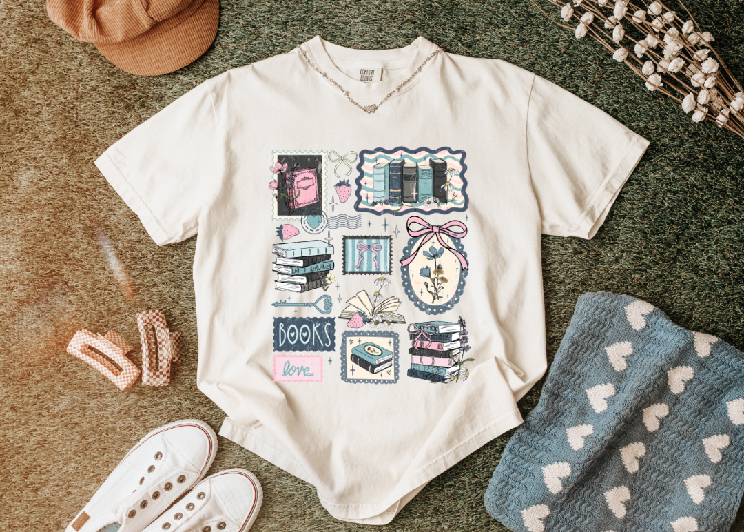 Beige shirt with graphic design on a textured surface with accessories.