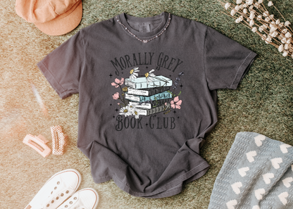 Gray t-shirt with 'Morally Grey Book Club' design on a textured surface.