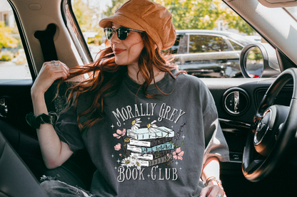 Woman sitting in a car wearing a 'Morally Grey Book Club' t-shirt.
