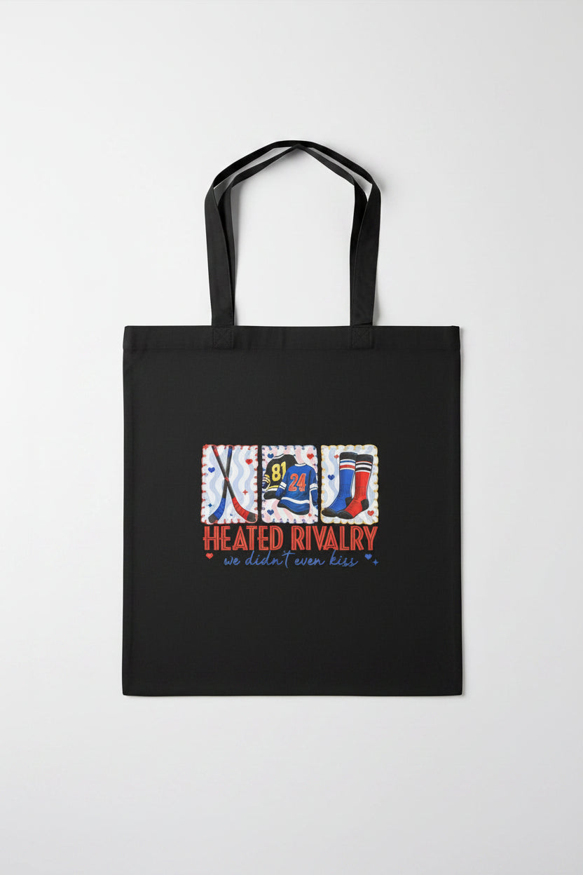Black tote bag with sports-themed design on a wooden surface