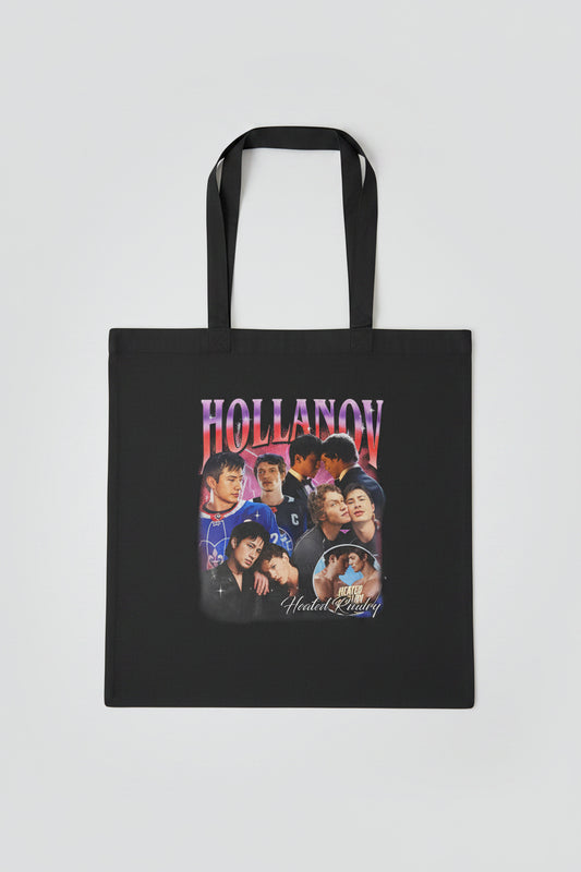 Black tote bag with 'Hollanov' graphic design on a wooden surface